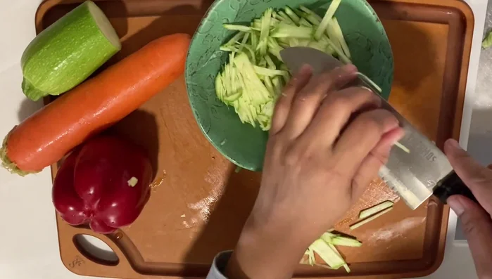 Add the vegetables: Gently fold the chopped vegetables into the batter. (Note: This step lacks detailed instructions from the audio.)