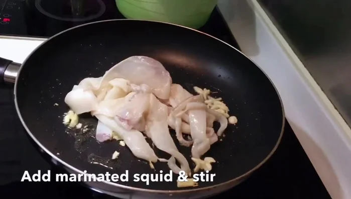 Add the squid and stir-fry until it turns white and slightly opaque.