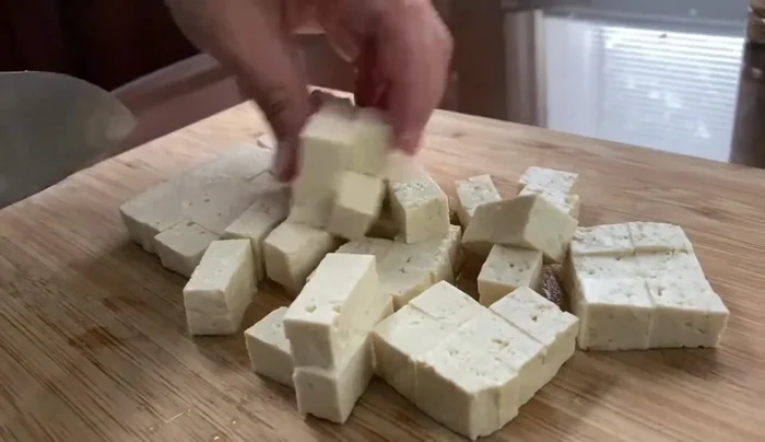 Continue cooking the tofu, potentially adding seasonings