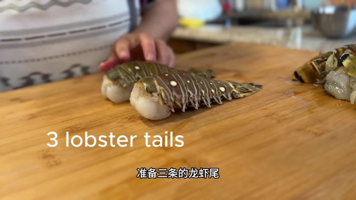 Cut the frozen lobster tails in half.