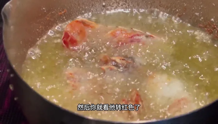 Fry until the shell turns red and separates from the meat, indicating it's cooked through.