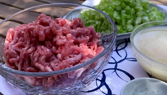 Prepare the wonton filling by mixing minced pork, chopped celery, chicken stock, fish sauce, salt, soy sauce, sesame oil, minced ginger, and white pepper. Stir in one direction while slowly adding the chicken stock until absorbed. (58.719)