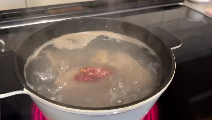 Reduce heat to medium-low and simmer for about 30 minutes, or until the broth turns milky white. (This will take approximately 1-1.5 hours for the meat to become tender)