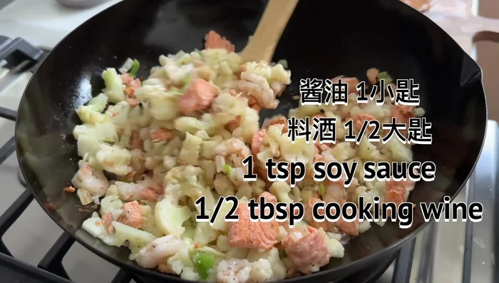Pour in a small amount of soy sauce and cooking wine. Add basmati rice, stir and heat everything through until evenly combined.
