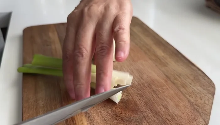 Prepare scallions and chop a small amount of onion.
