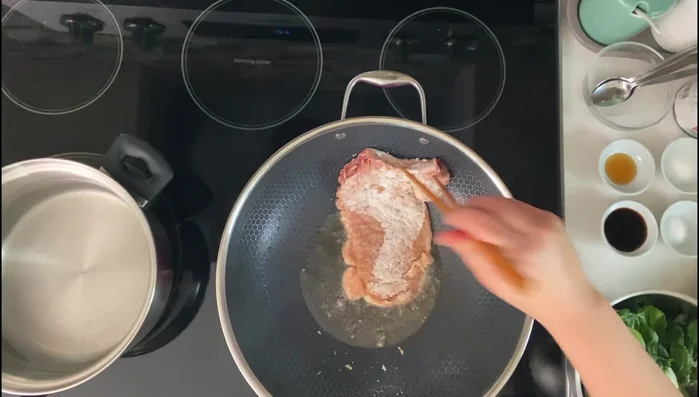 Fry the pork chops one at a time until golden brown.