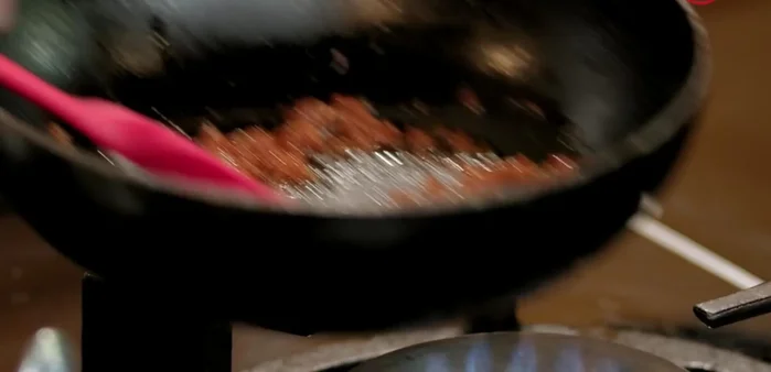 Add chicken stock gradually to the rice, stirring continuously. (Skip white wine for a stronger Thai flavor).