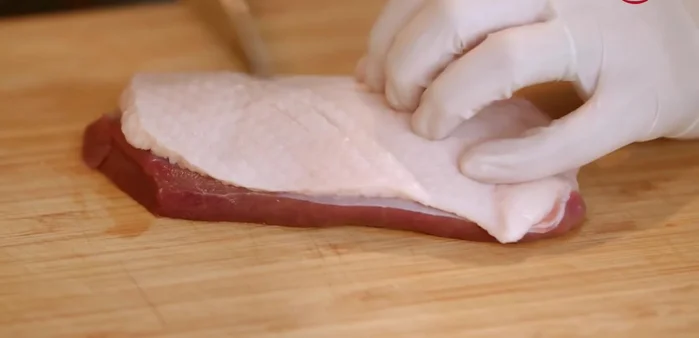 Score duck breast lightly, pierce the skin, and marinate with salt overnight to extract moisture and make it crispy.