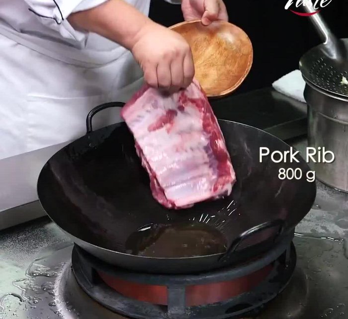 Prepare the ribs: This step involves cleaning and trimming the ribs, applying a dry rub (the exact recipe is not included).