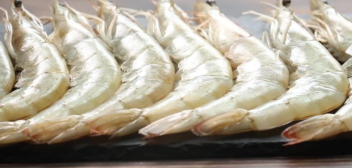 Prepare the shrimp by peeling and deveining. Chop vegetables into bite-sized pieces.