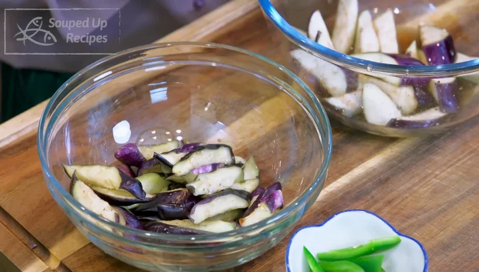 Squeeze excess moisture from salted eggplant, rinse, and squeeze again. Flip eggplant so skin side faces down.