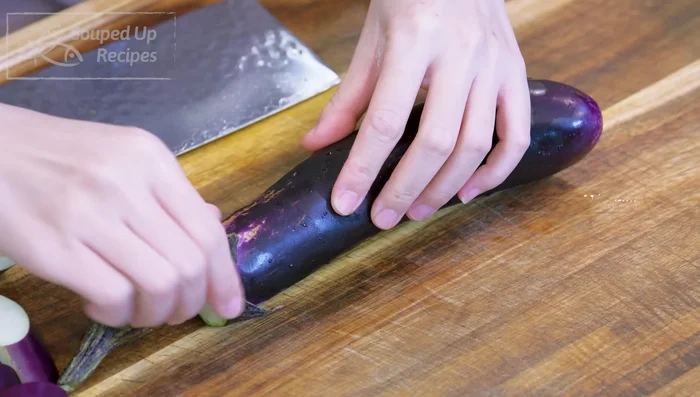 Cut eggplant in half lengthwise, then slice diagonally into 2/3 inch thick pieces. Rub with salt and set aside for 15 minutes.