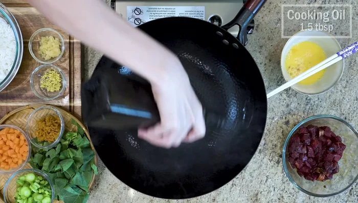 Heat wok until smoking hot. Add oil and swirl. Add beaten eggs, wait to set, then break into smaller pieces. Remove from wok.
