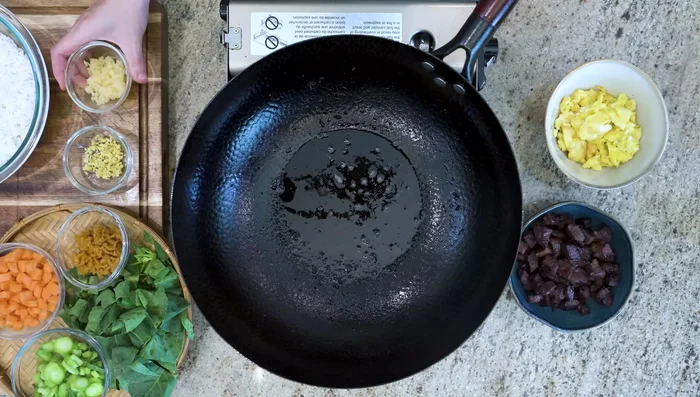 Add garlic, ginger, Taipo, carrot, and broccoli stems to wok. Stir until cooked.