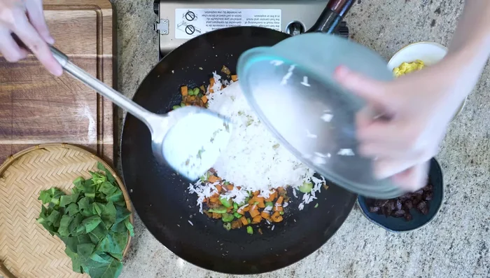Increase heat to high. Add rice and stir-fry until some grains are jumping (about a few minutes).