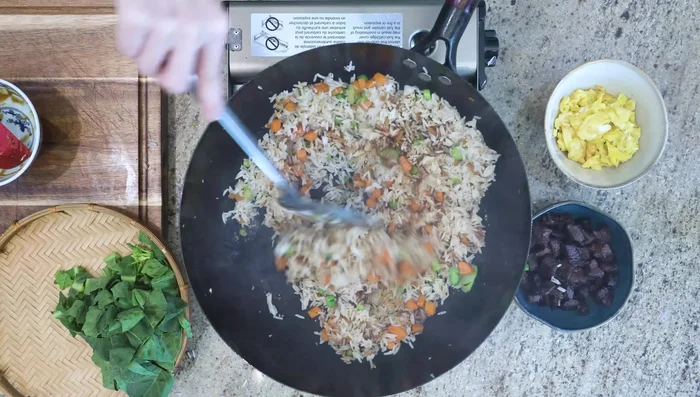 Add seasoning, stir until well mixed. Add egg and beef. Add broccoli leaves, stir until wilted.