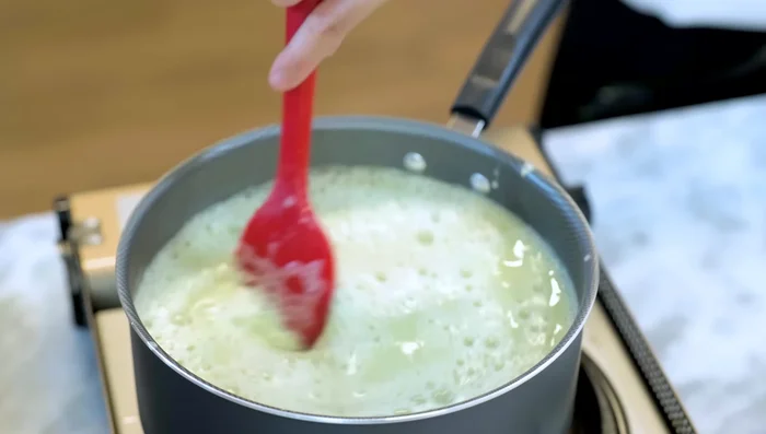 Pour the starch mixture into the hot liquid. Stir continuously for 10-12 minutes over medium-low heat, scraping the bottom of the pot to prevent burning.