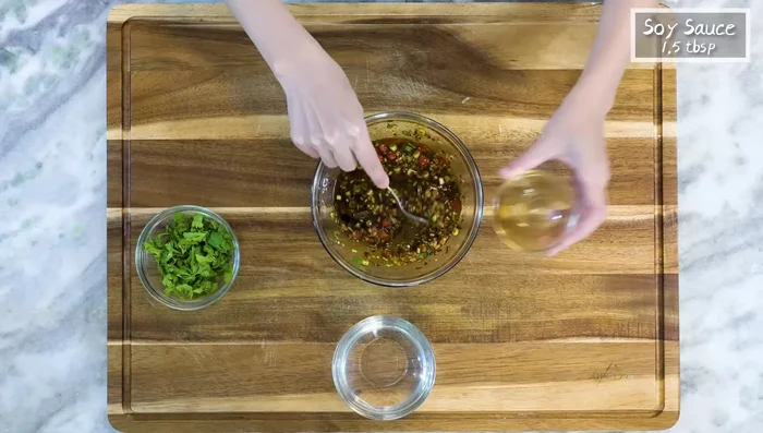 Add Chinese black vinegar, soy sauce, and water to the dressing. Stir well and adjust seasoning. Drizzle in sesame oil.