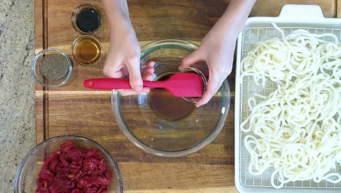 Prepare the sauce by combining soy sauce, oyster sauce, fish sauce, dark soy sauce, and freshly ground black pepper.