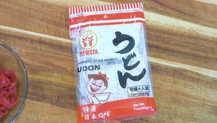 Cook udon noodles in boiling water until loosened, then immediately remove and spread on a rack to evaporate excess moisture.