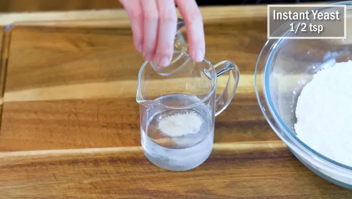 Make the dough: Combine water, salt, and yeast. Add oil and gradually mix in flour until a rough dough forms. Knead well for about 5 minutes until smooth.