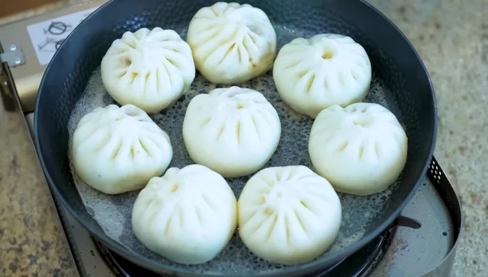 Once the water is mostly gone and the buns release easily, turn off the heat. Serve immediately.