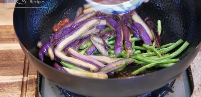 Return yard beans and eggplant to the wok. Pour in the sauce and stir over low heat until thickened.