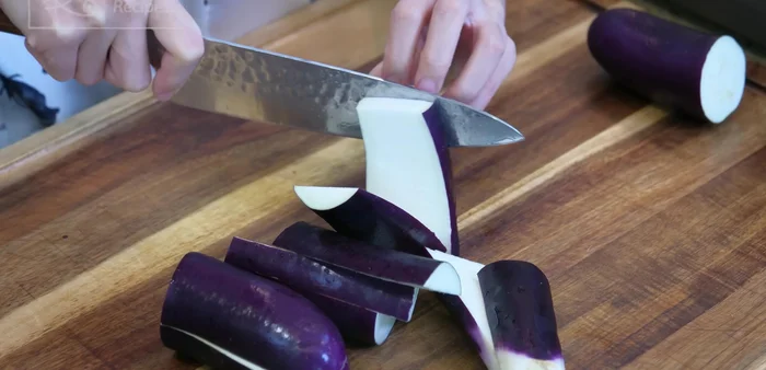 Cut eggplant into 3-inch long strips. Pre-season with salt to soften the flesh and prevent oil absorption.