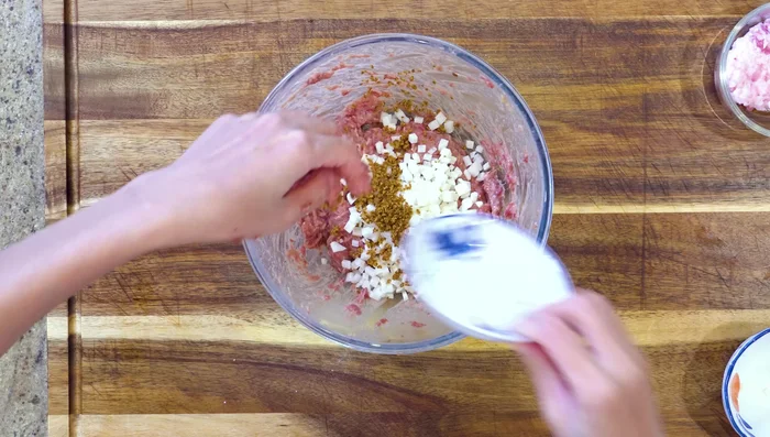 Combine ingredients: Add the diced jicama, pork fat, and cilantro (or scallions) to the beef mixture.