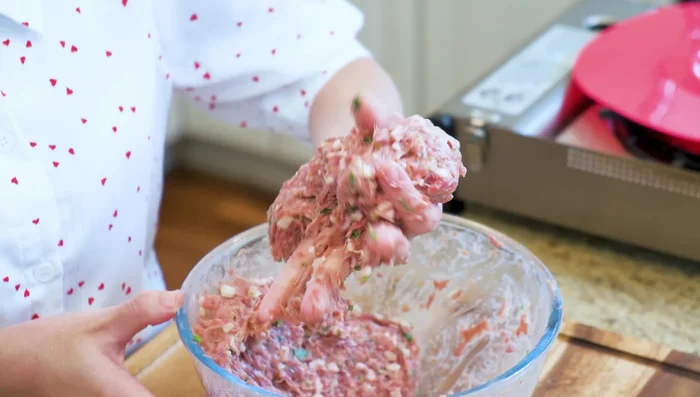 Form meatballs: Roll the mixture into meatballs (about 65 grams each) and place them on a plate lined with the prepared tofu skin.