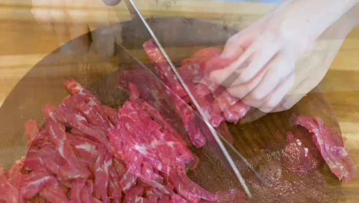Slice beef into ¼ inch thick slabs, then stack and cut into ¼ inch thick strips. Marinate with salt, five-spice powder, sugar, baking powder, soy sauce, dark soy sauce, grated ginger, and grated garlic. Set aside.