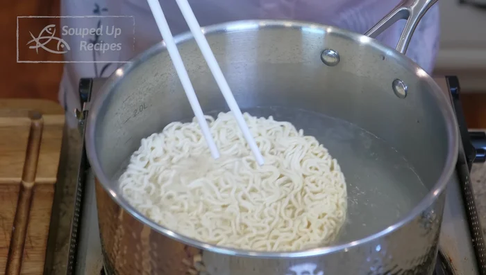 Cook noodles: Boil water, add instant noodles and cook to desired doneness. Blanch greens for 20 seconds.