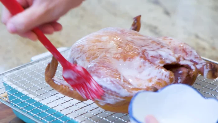 Dehydrate glazed chicken; coat with sesame seeds and dehydrate further.