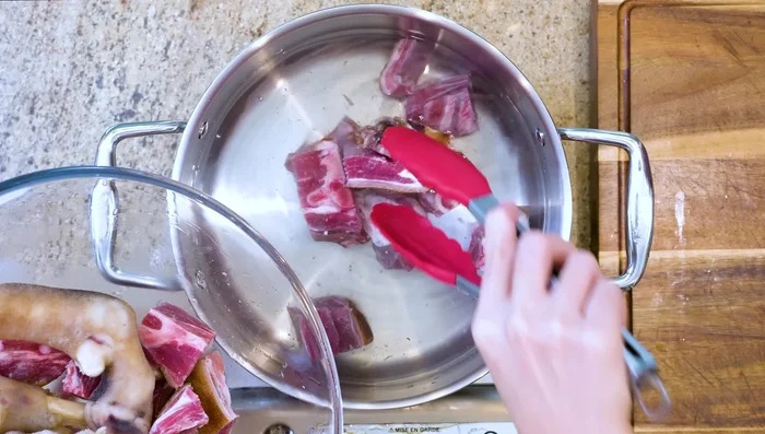 Prepare lamb soup (lamb belly, trotters, lemon tripe, onion, ginger, scallions). Simmer for 2 hours. Refrigerate.