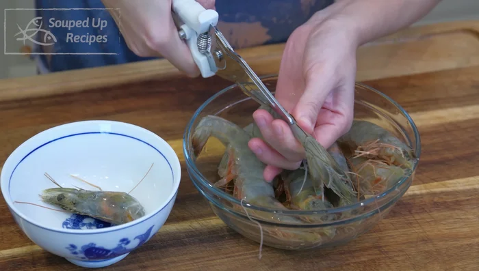 Prepare the seafood: Clean and devein the shrimp, cut open the squid tubes creating a criss-cross pattern, and pat scallops dry with paper towels. Season seafood with salt, pepper, and a drizzle of cooking oil.