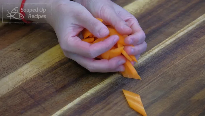 Prepare the vegetables: Slice the carrot, tear bok choy leaves, slice mushrooms, mince garlic, and slice ginger and shallot.