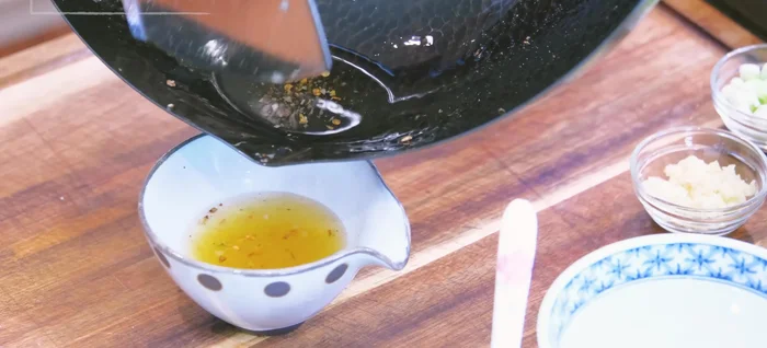 Remove most of the oil from the pan, leaving about 1 1/2 tbsp. Sauté garlic and scallions until fragrant.