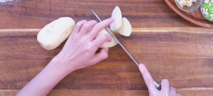 Peel potatoes and cut into chunks using a row cutting technique. Add to a pot with water, cook over medium heat for 10 minutes until halfway cooked.