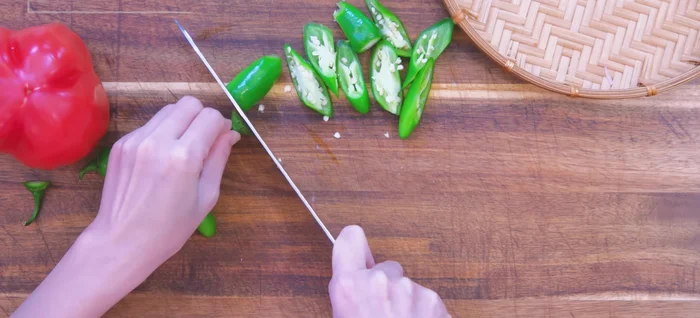 Prepare other ingredients: cut green chilies into triangles, dice red bell pepper, mince garlic, and chop scallions.