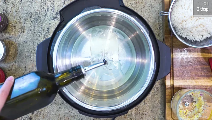 Sauté aromatics in oil in Instant Pot (or rice cooker/pot) until fragrant.
