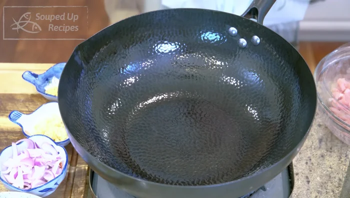 Heat a wok over high heat until smoking hot. Add a generous amount of oil, swirling to coat. Add marinated pork and stir-fry for 2 minutes until the color changes.
