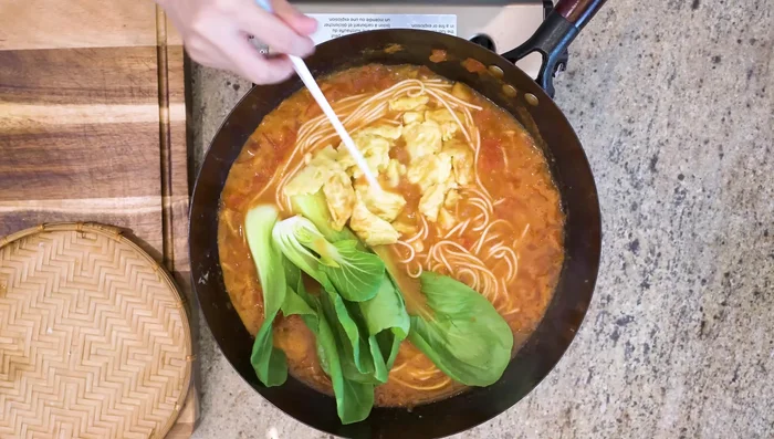 Return the egg to the wok. Add soy sauce to taste (adjust based on saltiness of stock).