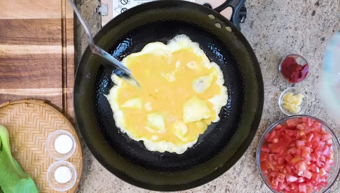 Pour in beaten eggs, let set, then break into chunks with spatula. Remove and set aside.