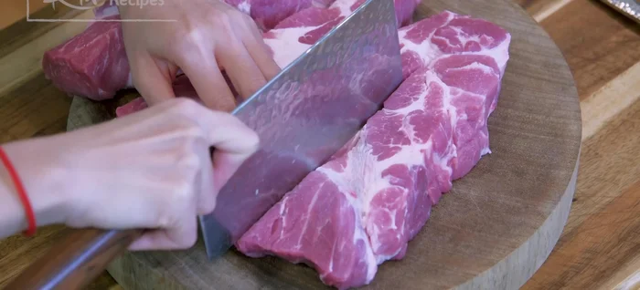 Prepare the pork: Cut the pork shoulder into 1 ½-inch thick slabs. Score the middle of each slab, and poke holes with a fork to help the marinade penetrate. (379.36)