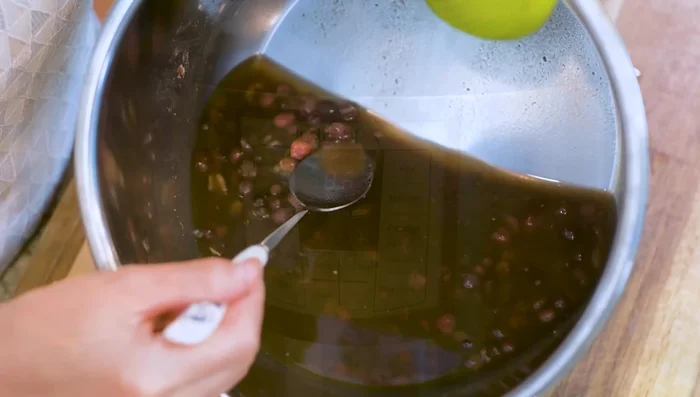 Once cooked, the beans should be soft and easily crushable. Let them cool to lukewarm.