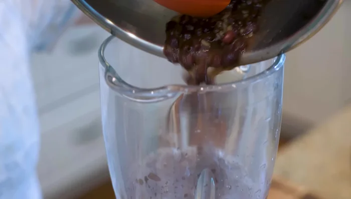 Blend the cooked beans and cooking liquid in a blender until smooth. Use as little additional water as possible.