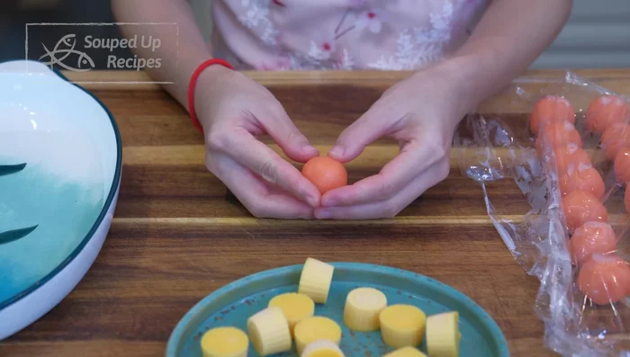 Remove lava filling from freezer and pop out of molds. Make a hole in the center of each custard ball and insert the lava filling. Wrap carefully.