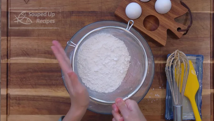 Sift in cornstarch and cake flour. Mix until no dry flour remains.