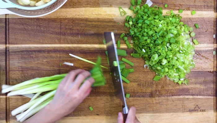 Prepare aromatics: chop scallions, ginger, garlic, and chilies.