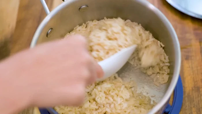 Fluff the cooked rice with a fork.